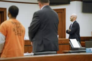 Chief Deputy Solicitor Sean Thornton listens to the judge as defendant Jayden Void, foreground, is sentenced for his role in the 2021 shooting death of D.J. Fields and the assault of two of his friends.